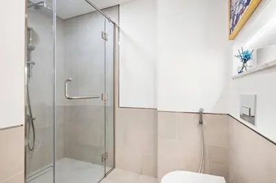 a bathroom with a glass shower with a toilet at StoneTree - Cozy 1 BR near Madinat Jumeirah and Burj Al Arab in Dubai