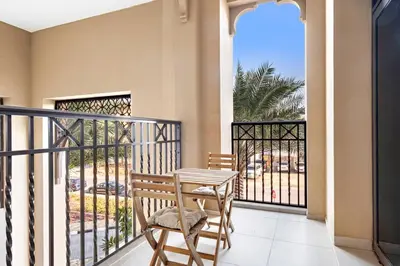 a balcony with a table and a chair on a porch at StoneTree - Cozy 1 BR near Madinat Jumeirah and Burj Al Arab in Dubai