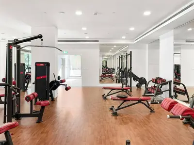 a gym with a lot of treadmills and machines at StoneTree - Cozy 1 BR near Madinat Jumeirah and Burj Al Arab in Dubai