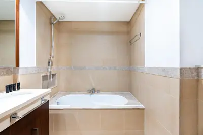 a bathroom with a tub and a sink at Vacay Lettings - Burj Vista Tower 1- Direct Dubai Mall Access in Dubai