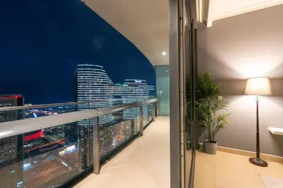a balcony with a view of a city at night at Vacay Lettings - Burj Vista Tower 1- Direct Dubai Mall Access in Dubai