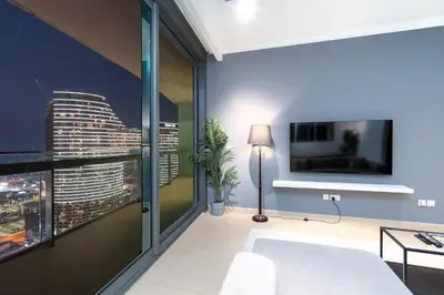 a living room with a view of a city at Vacay Lettings - Burj Vista Tower 1- Direct Dubai Mall Access in Dubai