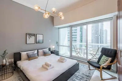 a bedroom with a bed and a large window at GuestReady Holiday Homes - Hibernate Hideout in Dubai