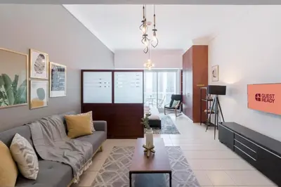 a living room with a couch and a table at GuestReady Holiday Homes - Hibernate Hideout in Dubai