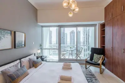a living room with a couch and a large window at GuestReady Holiday Homes - Hibernate Hideout in Dubai