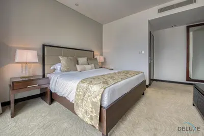 a large bedroom with a large bed and a night stand at Posh 1BR at The Address Residences Dubai Marina by Deluxe Holiday Homes in Dubai
