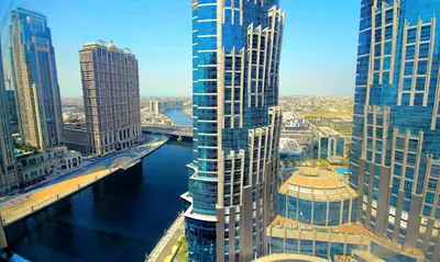 a view of a city with tall buildings and a river at RH- Beautiful Canal View, Cozy studio near metro station in Dubai