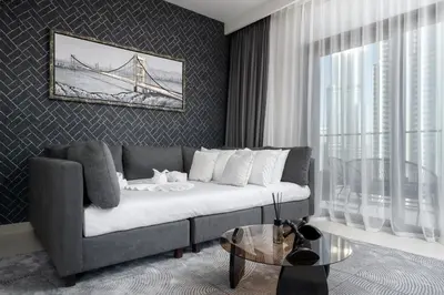 a living room with a couch and a glass table at Sky High Gem in Central Dubai with Burj Khalifa and Fountain Views in Dubai