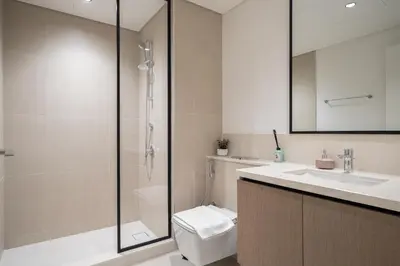 a bathroom with a shower and a toilet and a sink at Sky High Gem in Central Dubai with Burj Khalifa and Fountain Views in Dubai
