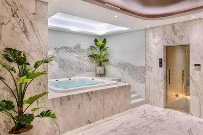 a bathroom with a jacuzzi tub and plants at Burj Khalifa Views 2BR with Infinity Pool Downtown in Dubai