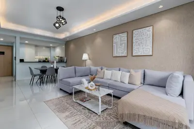 a living room with a blue couch and a table at Burj Khalifa Views 2BR with Infinity Pool Downtown in Dubai