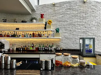 a kitchen with a counter with bottles on it at Burj Khalifa Views 2BR with Infinity Pool Downtown in Dubai