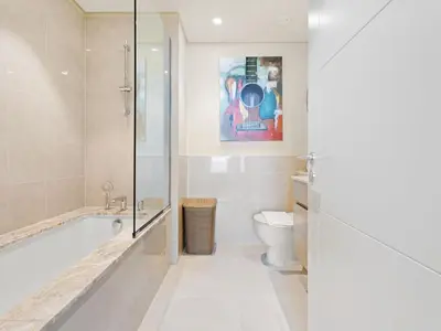 a bathroom with a tub and a toilet at Sophisticated and Trendy 2BDR In Forte Downtown in Dubai