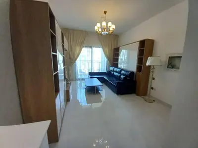 a living room with a couch and a table at StoneTree - Comfortable Studio in Arjan in Dubai