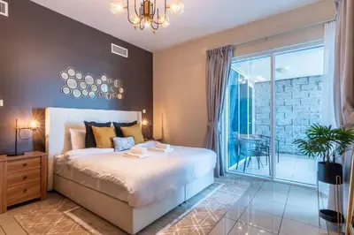 a bedroom with a bed and a large window at GuestReady - The Reflections at Dubai Marina in Dubai