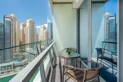 a balcony with two chairs and a table at GuestReady - Marina View Studio l With Balcony in Dubai
