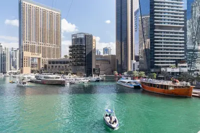a boat in a river in a city with buildings at GuestReady - Marina View Studio l With Balcony in Dubai
