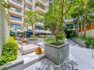 a courtyard in a building with trees and chairs at *Five Palm* 2bdr Private Beach in Dubai
