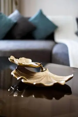 a bird sculpture sitting on a table in front of a couch at *Five Palm* 2bdr Private Beach in Dubai