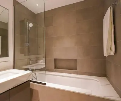 a bathroom with a shower and a tub and a sink at Your Elegance at Creek Harbour l 2BR in Dubai