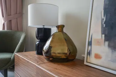 a lamp sitting on top of a table next to a lamp at Your Elegance at Creek Harbour l 2BR in Dubai