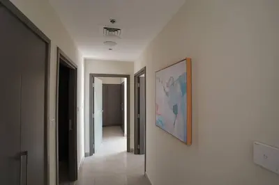 a hallway with a painting on a white wall at Your Elegance at Creek Harbour l 2BR in Dubai