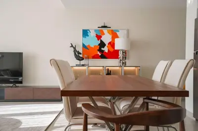 a dining room with a wooden table and chairs at Your Elegance at Creek Harbour l 2BR in Dubai