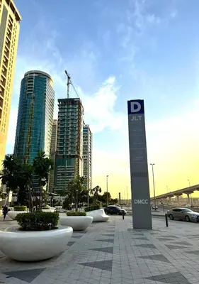 a parking lot with a sign in front of some buildings at Lake View 1BR Apt Balcony & Near DMCC Metro in Dubai