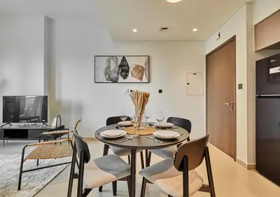 a kitchen and dining room with a table and chairs at Lux 1 BD Apartment, 2 Min walk to Dubai Mall & Burj Khalifa - Act One Tower in Dubai