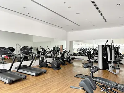 a gym with a lot of treadmills and machines at Silkhaus Luxury Studio in Residential Neighborhood in Dubai