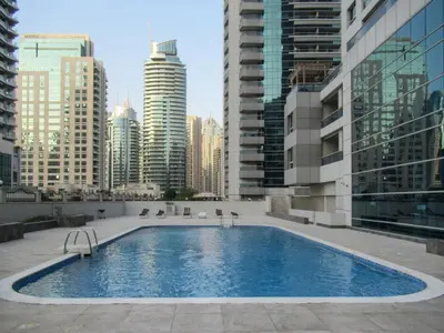 a large swimming pool in a city with tall buildings at GuestReady - Bright 1BR with Balcony & Marina View in Dubai