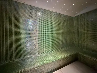 a bathroom with green tiled walls and a window at Ultra Luxury Dubai Marina I LIV Residence in Dubai