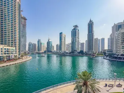 a river in the middle of a city with tall buildings at Ultra Luxury Dubai Marina I LIV Residence in Dubai