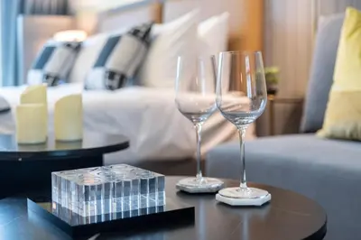two wine glasses sitting on a table in a living room at GuestReady – Downtown Studio l City View l Balcony in Dubai