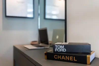 a stack of books sitting on a desk with a laptop at GuestReady – Downtown Studio l City View l Balcony in Dubai
