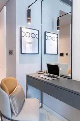 a office with a desk with a laptop and a chair at GuestReady – Downtown Studio l City View l Balcony in Dubai