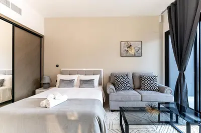a bedroom with a bed and a couch at HAVN - Studio in Business Bay, Burj Khalifa View in Dubai
