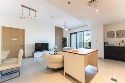 a living room with a table and chairs and a living room at HAVN - 2 Bedroom in Bayshore, Dubai Creek Harbour in Dubai