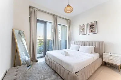a bedroom with a bed and a large window at HAVN - 2 Bedroom in Bayshore, Dubai Creek Harbour in Dubai