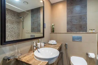a bathroom with a sink and a mirror at GuestReady- Holiday Homes - Cyan Sky View in Dubai