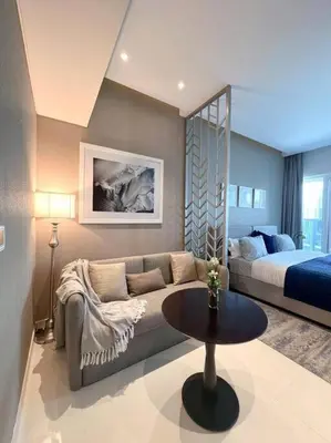 a living room with a couch and a bed at Deluxe Studio Business Bay - Canal View - Gym & Pool in Dubai