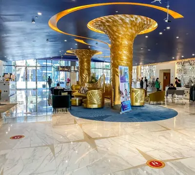 a lobby with two gold columns in a building at Deluxe Studio Business Bay - Canal View - Gym & Pool in Dubai