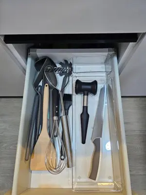 a plastic container filled with utensils in a drawer at Cozy Studio - Dubai Marina - 5 Min to Beach and Metro in Dubai