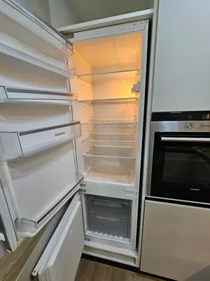 an empty refrigerator with its door open in a kitchen at Cozy Studio - Dubai Marina - 5 Min to Beach and Metro in Dubai