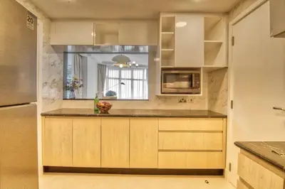 a kitchen with white cabinets and a counter top at The Smart Concierge - Avant in Dubai