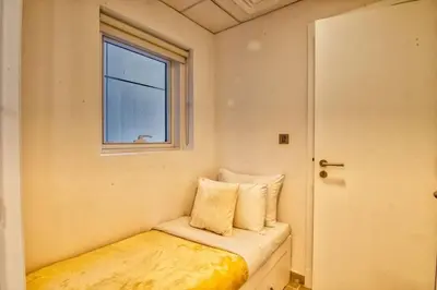 a small bed in a room with a window at The Smart Concierge - Avant in Dubai