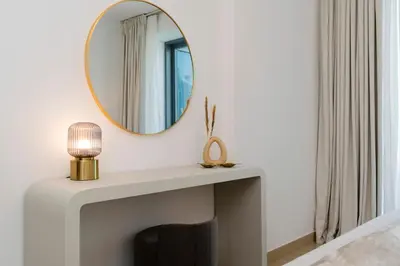 a mirror above a fireplace in a living room at Prestige Living 2BR with Full Burj Khalifa and Fountain View by Auberge in Dubai