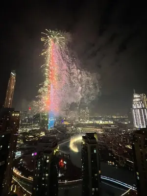 a firework display in a city at night at Prestige Living 2BR with Full Burj Khalifa and Fountain View by Auberge in Dubai