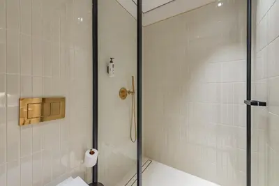 a shower with a glass door in a bathroom at Studio with Burj Khalifa View - Upside Living in Dubai