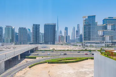 a view of a city with a highway and buildings at Studio with Burj Khalifa View - Upside Living in Dubai